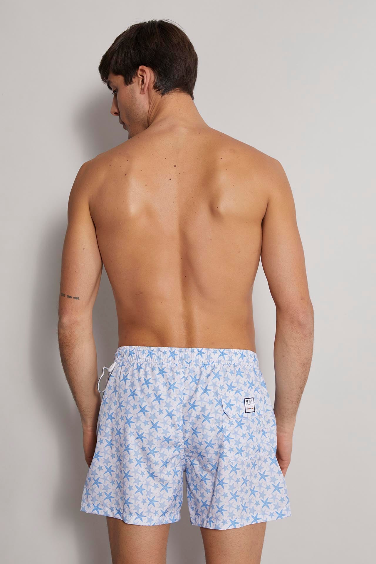 Men's sustainable designer swim trunks with blue stellamarina patterns Madeira